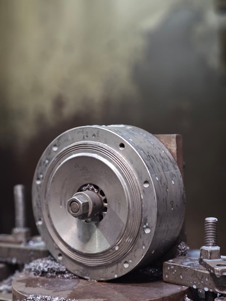 Precision machined metal component with coolant and swarf in the workshop